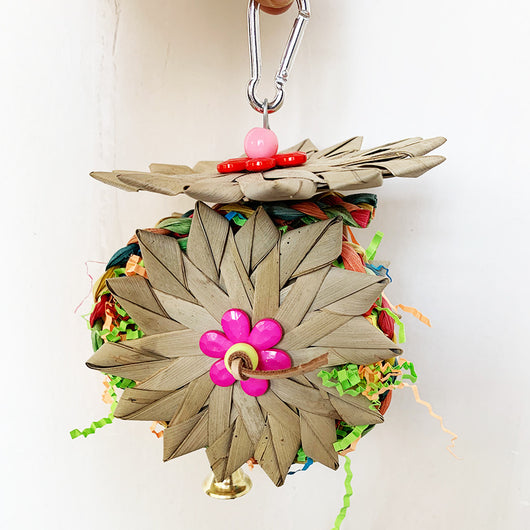 Colorful parrot chew toy made from natural fibers, featuring a woven ball, leaf-like accents, a bell, and a carabiner clip. - Image 15