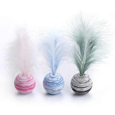White foam cat toy ball with blue swirl patterns and a light blue feather on top, for feline play. - Image 3