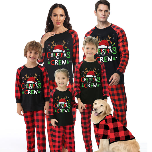 Man wearing a Christmas pajama set with a black long-sleeve top and red and black buffalo plaid pants.