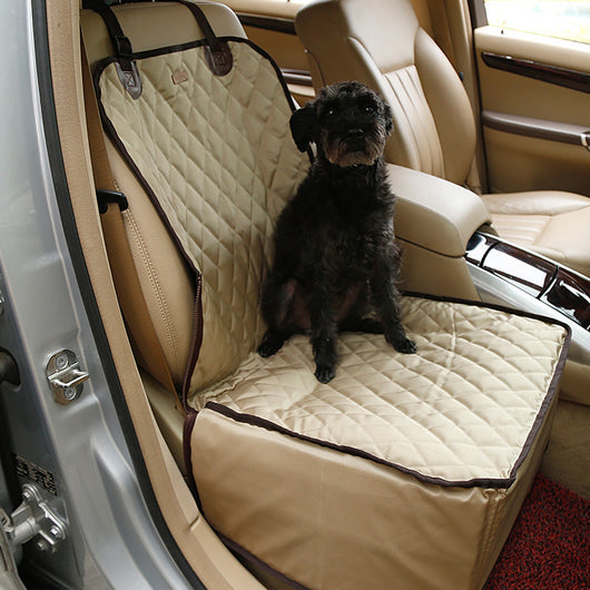 Black quilted waterproof pet car seat for front passenger seat, with a small black dog sitting inside.