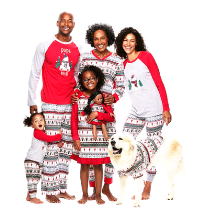 Woman wearing a grey and red 'Mama Bear' Christmas pajama set with a polar bear graphic and fair isle patterned pants.
