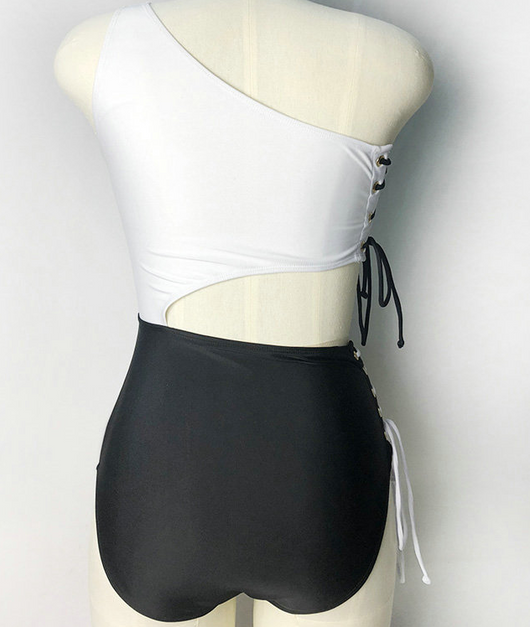 Black and white one-piece bikini with a one-shoulder white top and high-waisted black bottom, featuring lace-up sides. - Image 3