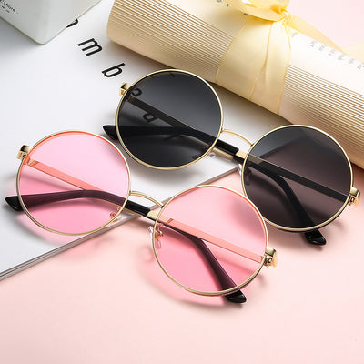 Round gold metal frame sunglasses with brown lenses and glitter detail on the outer rim, featuring dark red temple tips. - Image 3