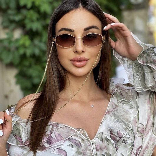 Women's hexagonal sunglasses with dark lenses, gold-colored metal frame, black temples, and a detachable gold chain. - Image 18
