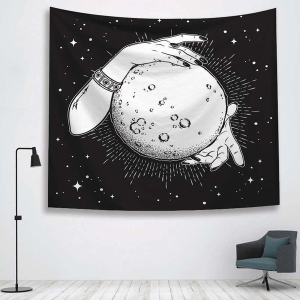 Black and white tapestry featuring two hands holding a full moon against a starry night sky, hanging on a white wall. - Image 4