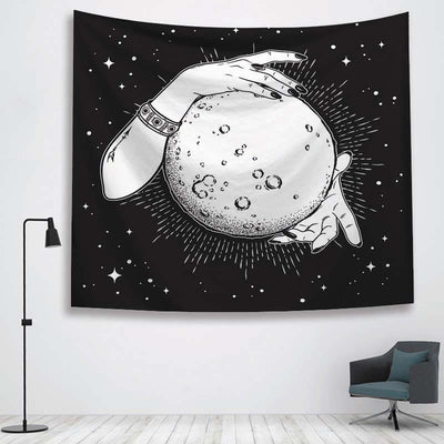 Black and white tapestry featuring two hands holding a full moon against a starry night sky, hanging on a white wall. - Image 4