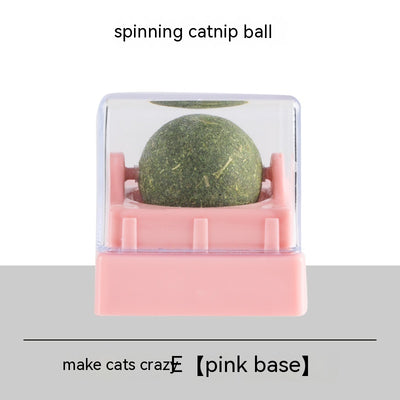 Two spinning catnip balls, one with a green base and one with a blue base, in clear plastic cases. - Image 4