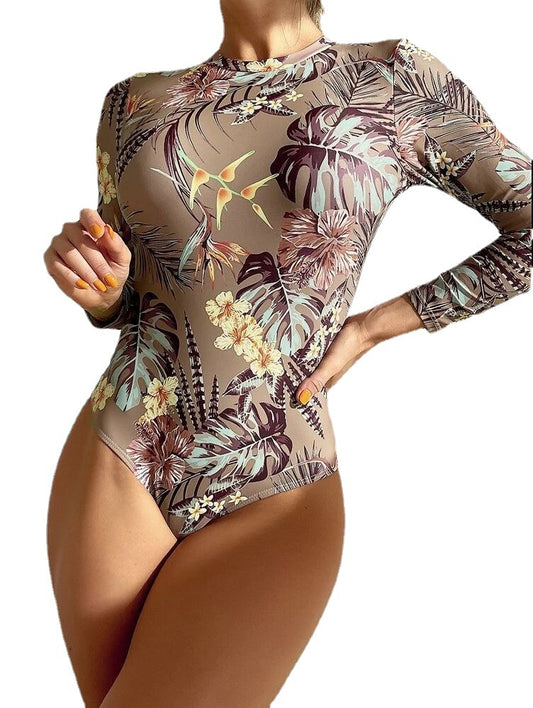 Women's pink long-sleeve one-piece swimsuit with a vibrant tropical leaf and floral print. - Image 2