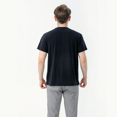 Young boy wearing a white short-sleeve t-shirt with blue tropical leaf print and a black chest pocket. - Image 12