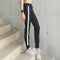 Pantalones deportivos con bolsillos laterales a rayas