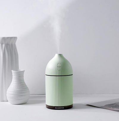 Pink ribbed aromatherapy diffuser and ultrasonic humidifier with a transparent brown base and control buttons. - Image 4