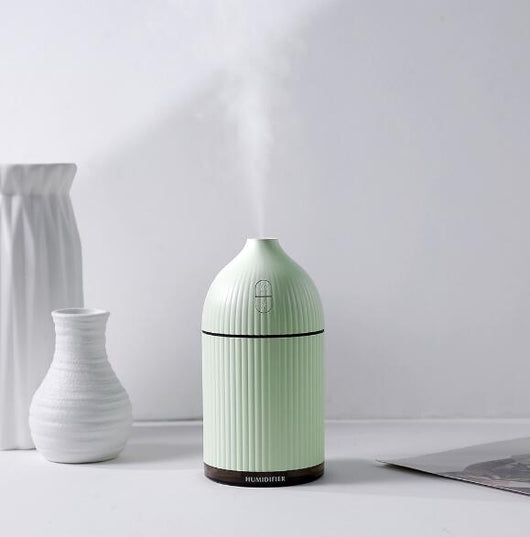 Pink ribbed aromatherapy diffuser and ultrasonic humidifier with a transparent brown base and control buttons. - Image 4