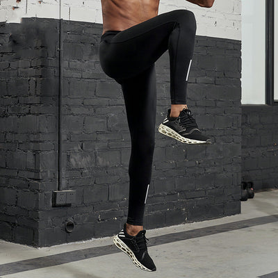Black men's fitness pants with a tight fit, elastic waistband, and reflective strips on the lower legs. - Image 9
