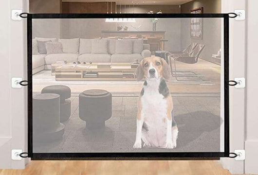 Black mesh pet gate installed at the bottom of a wooden staircase, with a golden retriever sitting in front. - Image 19