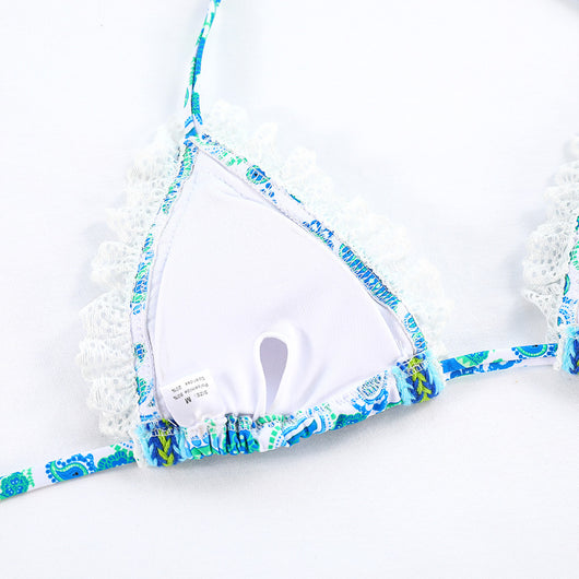 Women's blue and green paisley print bikini with white lace trim, triangle halter top, and tie-side bottoms. - Image 13