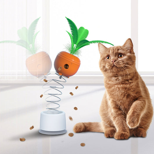 Orange carrot-shaped cat leaking food toy with green leaves, designed as a self-playing tumbler feeder.