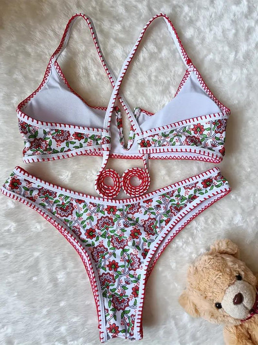 White two-piece swimsuit with red and green floral print, V-neck top, criss-cross straps, and high-cut bottoms. - Image 5