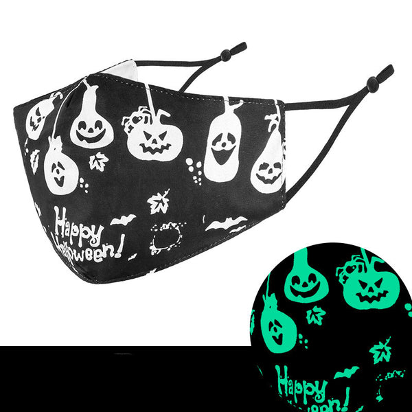 Black cloth face mask with white Halloween witch, bats, and jack-o'-lantern pattern, shown glowing green in the dark. - Image 5