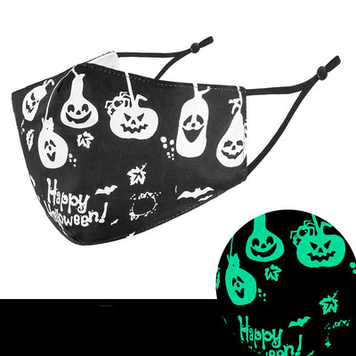 Black cloth face mask with white Halloween witch, bats, and jack-o'-lantern pattern, shown glowing green in the dark. - Image 5