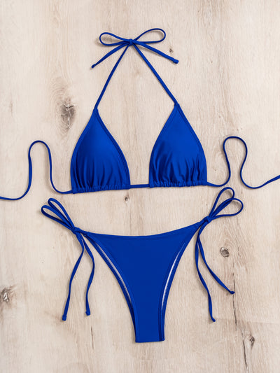 Neon yellow halter bikini with triangle top and tie-side bottoms, displayed on a light wood surface. - Image 26