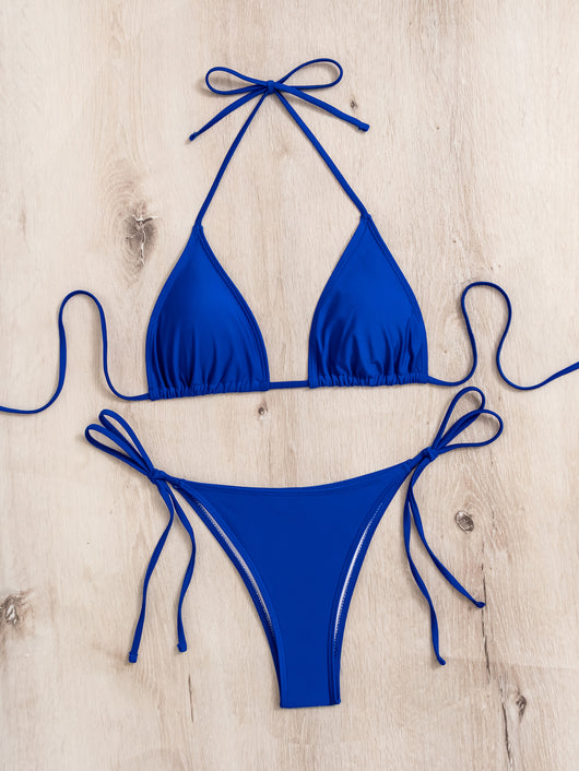 Neon yellow halter bikini with triangle top and tie-side bottoms, displayed on a light wood surface. - Image 26