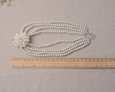 Luxury bridal pearl necklace and earring set with a multi-strand design and rhinestone flower accent. - Image 6