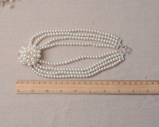 Luxury bridal pearl necklace and earring set with a multi-strand design and rhinestone flower accent. - Image 6