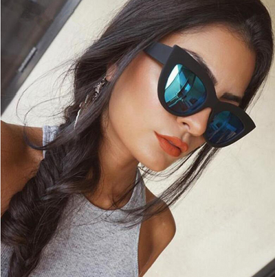 White and black cat eye sunglasses with gradient lenses, featuring a retro style.