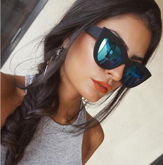 White and black cat eye sunglasses with gradient lenses, featuring a retro style.
