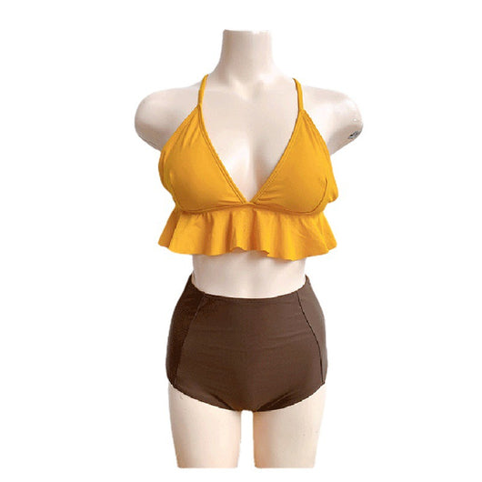 Woman in a yellow ruffled bikini top and dark brown high-waisted bottoms sitting on a beach. - Image 5