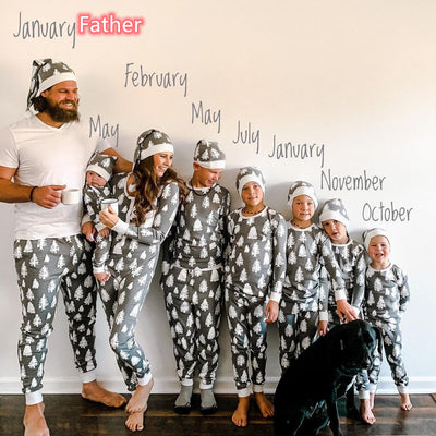 Family of seven and a dog in matching grey Christmas tree print pajamas with white cuffs and beanies. - Image 9