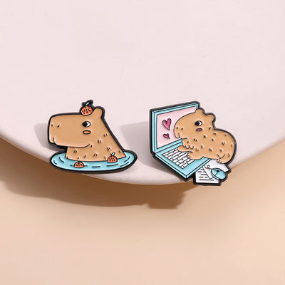 Cute capybara enamel brooch wearing a pink donut with sprinkles and "DONUT WORRY BE CAPPY" text. - Image 38