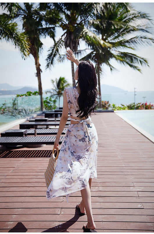 Women's three-piece swimwear set with a cream floral print, ruffled crop top, high-waisted shorts, and matching sarong. - Image 15