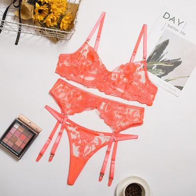 Purple embroidered lace three-piece lingerie set with underwire bra, thong, and garter belt on a white surface. - Image 3