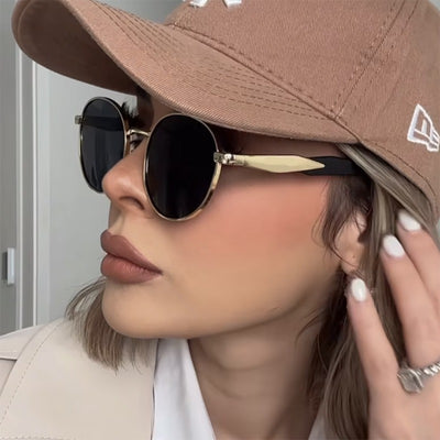 Silver metal round frame sunglasses with dark grey lenses and black temples, offering UV protection for women. - Image 2
