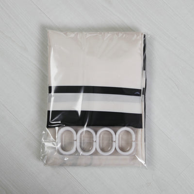 Black and white striped polyester shower curtain with a crown and text design, hanging from a silver tension rod. - Image 3