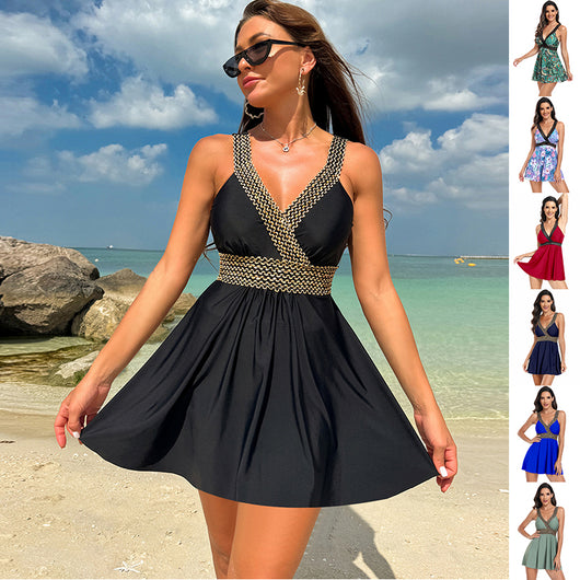 Royal blue V-neck swimsuit dress with gold and black patterned trim on neckline and empire waist.