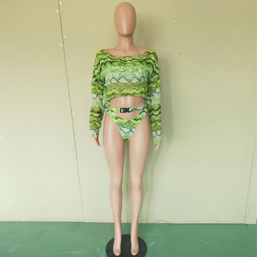 Woman in a purple and pink snakeskin print three-piece swimsuit with an off-shoulder crop top and high-waisted bottoms. - Image 25