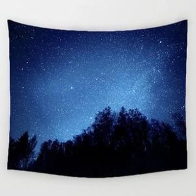 Rectangular tapestry featuring a dark blue starry night sky with a silhouette of a forest along the bottom.