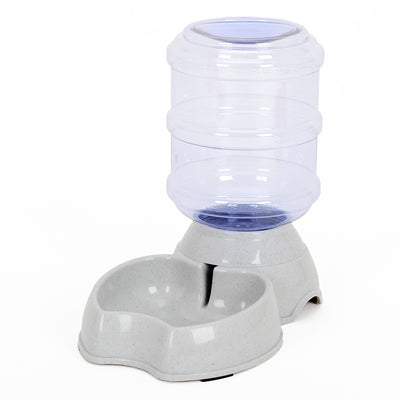 White pet feeding station with a stainless steel food bowl and a clear automatic water dispenser bottle. - Image 6