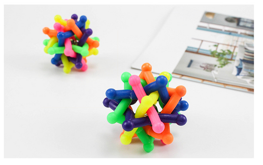 Colorful rainbow pet chew toy ball made of soft rubber with an interlocking design and an internal bell. - Image 3
