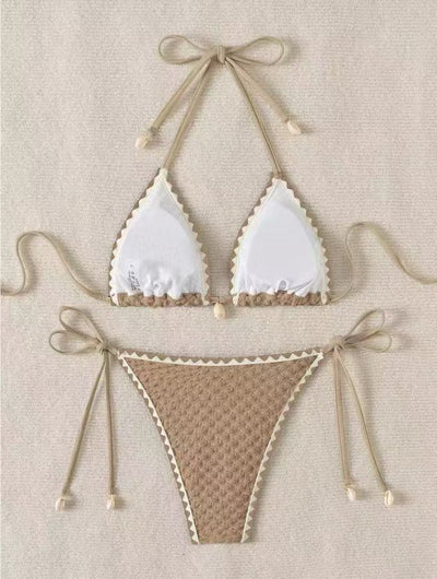 Black textured bikini with white scalloped trim, halter top, and tie-side bottoms featuring small shell details. - Image 9