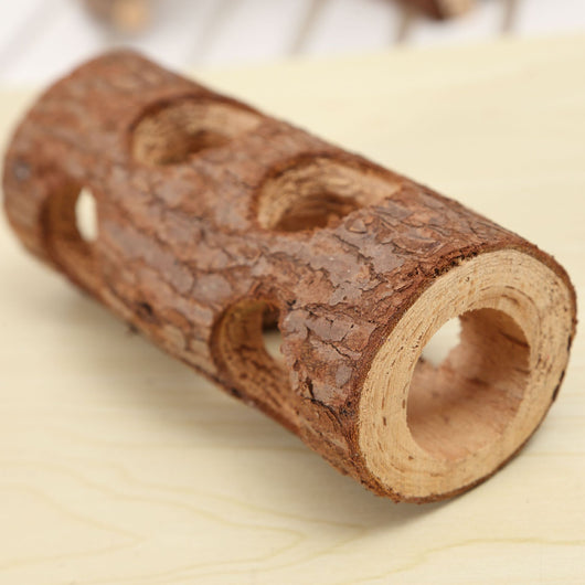 Natural solid wood pipe with bark texture and multiple holes, serving as a chew toy or hideout for small pets. - Image 7