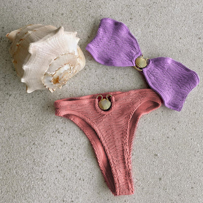 Women's purple tube top and coral high-cut bikini with textured fabric and gold shell hardware, displayed with a conch shell. - Image 2