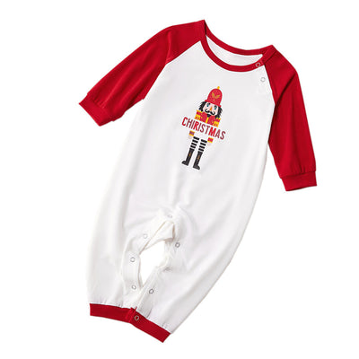 Matching family Christmas pajamas with white raglan tops, red sleeves, and a nutcracker graphic, paired with red, green, and white striped pants. Includes adult - Image 5