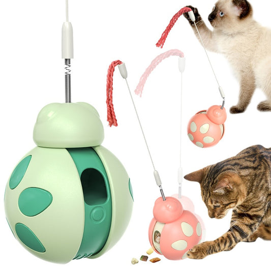 Green and light green plastic cat food leakage toy with a spherical body, cutouts, and a braided rope.