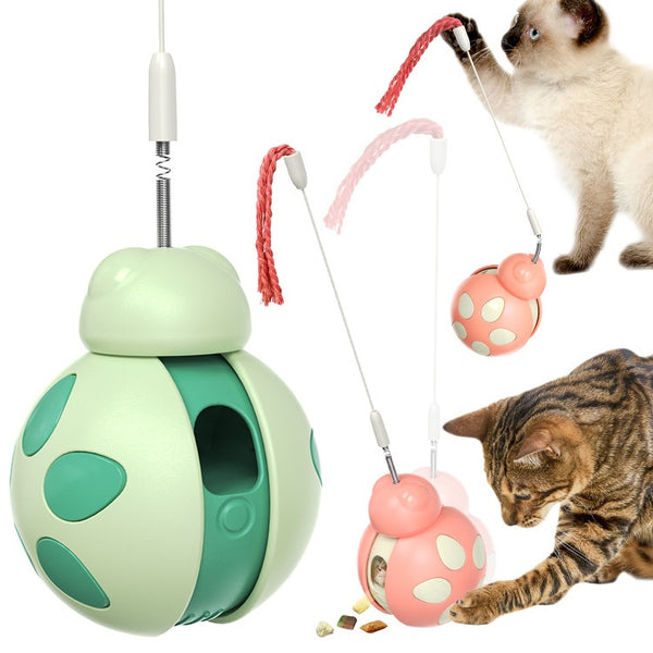 Green and light green plastic cat food leakage toy with a spherical body, cutouts, and a braided rope.