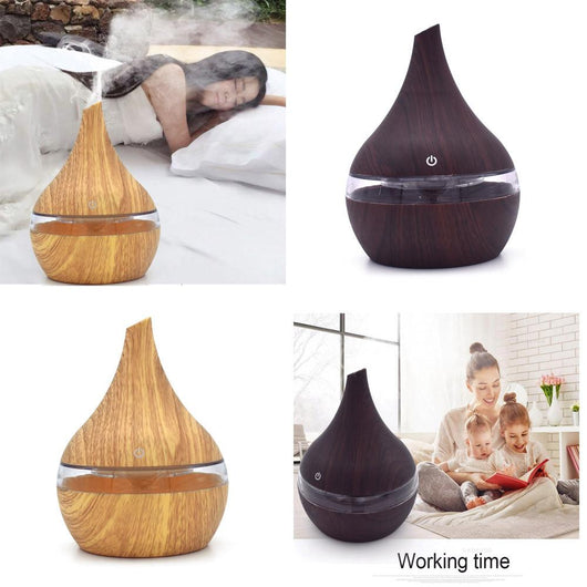 Dark wood grain LED essential oil diffuser with a blue light band and touch switch, shown with a hand operating it. Includes a bundle of 10 white filter sticks. - Image 4