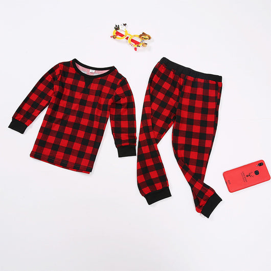 Red and black plaid long-sleeve family pajamas, including adult, child, and baby sizes, with festive accessories. - Image 10