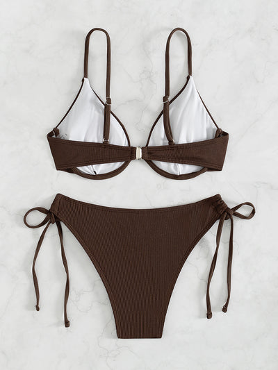Black ribbed two-piece bikini with an underwire top and tie-side bottoms on a white marble surface. - Image 18